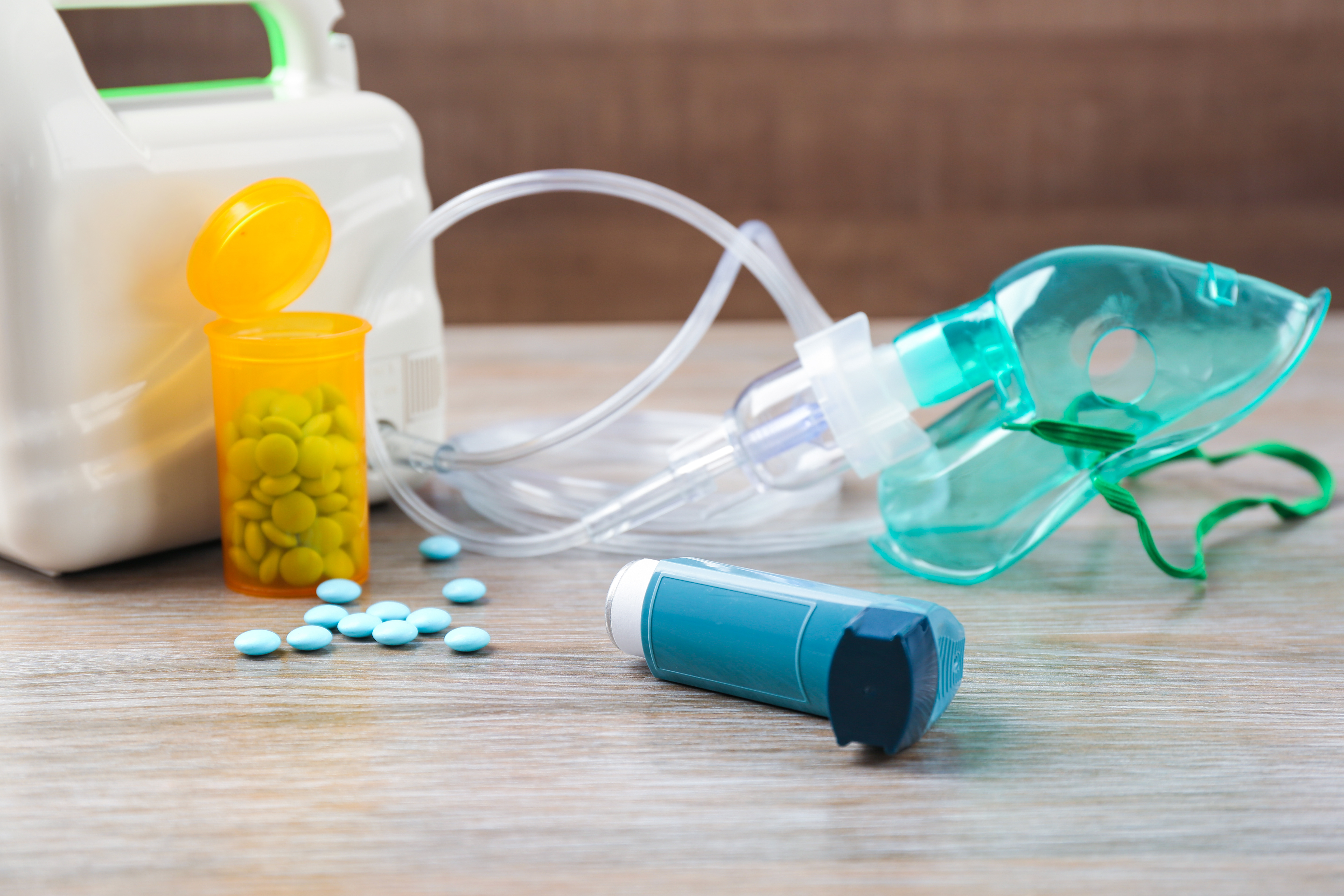 A photo of an asthma inhaler, nebulizer, and bottled medication.