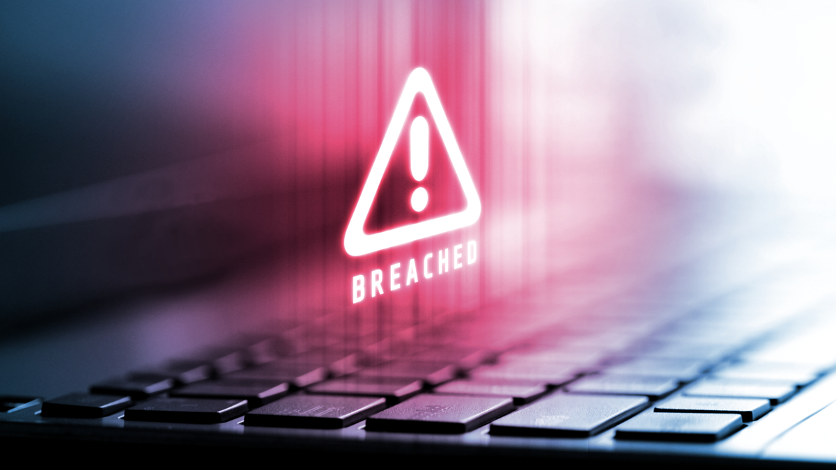 CyberSecurityBreach_259663909 A caution symbol hovers above a keyboard.