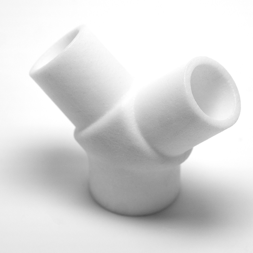 A white, Y-shaped ventilator expansion splitter.